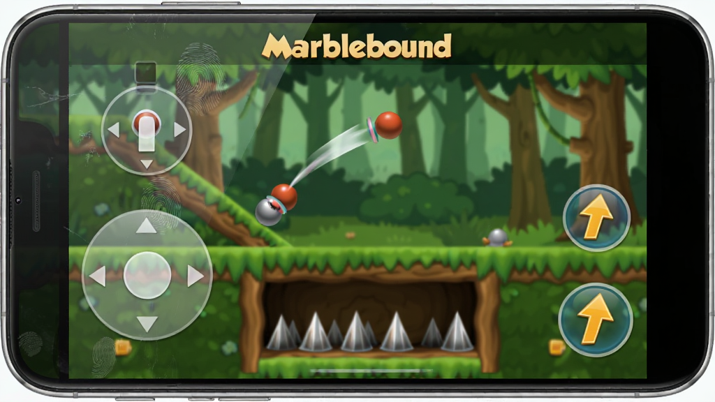一部智能手机屏幕显示Marblebound游戏界面,画面中弹珠正从一个斜坡弹射到空中,下方是带有尖刺的陷阱区域,屏幕左侧有虚拟摇杆半透明控件,右侧有跳跃按钮,背景是游戏内的森林关卡场景,风格为手机游戏截图风格,细节包括屏幕上的指纹痕迹、手机边框的金属光泽,画质清晰干净,无多余元素,屏幕上方有