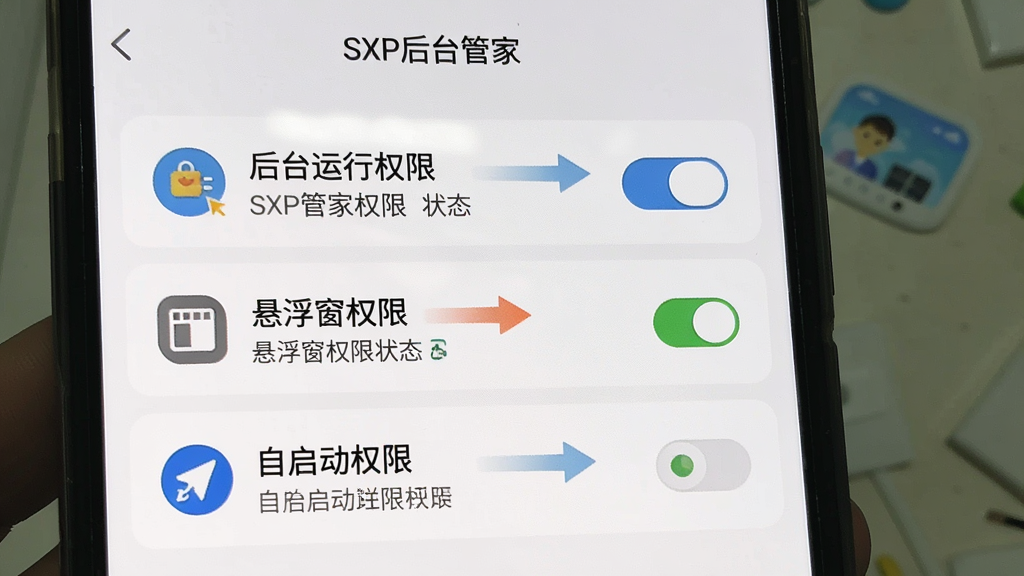 一张展示SXP后台管家权限设置引导页面的图片,画面为手机屏幕特写,屏幕上依次列出“后台运行权限”、“悬浮窗权限”、“自启动权限”三个选项,每个选项旁有开关按钮与状态指示,界面以浅色背景为主,图标采用扁平化设计,风格简洁明了,细节上体现引导箭头与提示文字,画质清晰干净,无多余元素,图片中文字包含“SXP后台管家”